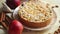 Freshly baked homemade apple pie with almond flakes cake on yellow