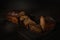 Freshly baked homemade artisan sourdough bread on wooden boards over dark background