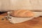 Freshly baked homemade bread with bran on a wooden background and burlap and with a willow sprig. Foodphoto