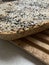 Freshly baked homemade bread with crust, wooden board for cutting bread, seeds and cereals on bread from a mold, black cumin, sunf