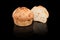 Freshly baked homemade bread isolated on black. Cut in half cheese and onion bread. Healthy eating and traditional bakery, baking