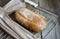 Freshly baked homemade bread on rustic dark wood background