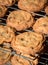 Freshly baked homemade chocolate chip cookies cooling on metal racks