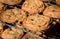 Freshly baked homemade chocolate chip cookies cooling on two wire racks