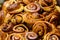 Freshly baked homemade English cinnamon rolls displayed as a pyramid, available for sale at a cafÃ© in London, selective focus