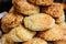 Freshly baked homemade English scones with dried fruits, displayed as a pyramid, available for sale at a cafe