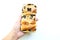 freshly baked homemade loaf of bread with stuffed raisin in Asian woman\\\'s hand isolate on a white backdrop