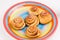 Freshly baked homemade snail buns with sugar and cinnamon  on striped plate. Balanced nutrition, proteins and carbohydrates,