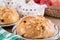 Freshly baked, homemade sweet cake with almonds and raisins on wooden table. Easter loaf. Basket with pears and apples. Tea pot