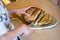 Freshly baked irish soda bread, with cutted cross - cutted into slices by young girl. Healthy, home made, delicious pastry