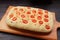 Freshly Baked Italian Tomato and Garlic Focaccia Bread on Wooden Breadboard