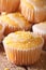 Freshly baked lemon muffins with frosting macro. Vertical