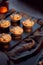 Freshly Baked Mince Pies On Table Set For Christmas With Cinnamon Sticks And Orange