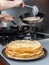 Freshly baked pancakes stacked on a platter from which steam comes. Traditional treat for the holiday of Maslenitsa