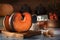 Freshly baked pieces of pumpkin stand against the background of kitchen utensils and a basket with Physalis.