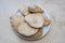 Freshly baked pitta bread served on a white plate