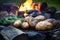 freshly baked potatoes on cool stones near spent campfire