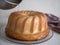 Freshly-baked rum baba. Pouring the syrup over the Savarin