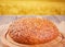 Freshly baked rye bread with cereal and seeds and wheat stems on wooden kitchen table. Top view. Copy space