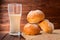 Freshly baked sliced buns and glass of milk