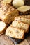 Freshly baked sliced pineapple bread with walnuts close-up. vert