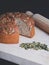 A freshly baked sourdough bread with pumpkin seeds and a rolling pin on a wooden surface