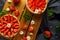 Freshly baked Strawberry custard tarts on wooden tray with camomiles, summer theme