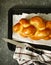 Freshly baked sweet braided bread loaf on a baking sheet. Chall