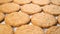 Freshly baked warm oatmeal cookies on a wooden background.