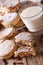 Freshly baked Welsh cakes with raisins and milk close-up. vertical