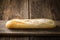 Freshly baked white baguette on a wooden background