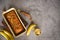 Freshly baked wholesome banana bread, on grey background with banana, cinnamon and nuts. Horizontal with copyspace.