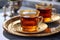 Freshly brewed black tea in turkish glasses in oriental tray