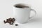 Freshly brewed coffee in a white mug with coffee beans