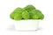 Freshly broccoli in white earthenware bowl on background