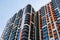 freshly built high rise apartment buildings on blue sky background at sunny day