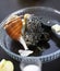 Freshly caught broken large raw sea snail on glass plate