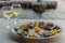 Freshly caught oysters on a plate and vine glasses. Restaurant on the shores of the Bay of Kotor near the oyster farm