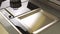 A freshly cleaned glass surface of an electric cooker built into the kitchen worktop. Household utensils. Close up view