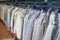 Freshly cleaned men`s shirts and ladies blouses in a textile cleaning