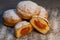 Freshly cooked Apricot jam doughnuts, referred to as jelly doughnuts, donuts in the US