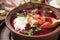 Freshly cooked borscht - traditional dish of Russian and Ukrainian cuisine in earthenware dishes with bacon, bread, sour