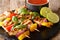 Freshly cooked grilled chicken skewers with vegetables with sauce and lime closeup. horizontal