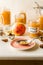 Freshly cooked homemade applesauce in glass jars, ingredients, pink plate and spoon on kitchen table, closeup view