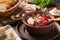 Freshly cooked hot homemade borscht - traditional dish of Russian and Ukrainian cuisine in earthenware dishes with bacon