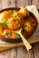 Freshly cooked Indian potatoes Dum aloo in curry sauce close-up. verical