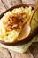 Freshly cooked mashed potatoes with caramelized onions close-up on a plate. vertical