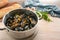 Freshly cooked mussels in a pot, bread, herbs and a blue towel on a wooden kitchen table, healthy seafood meal, copy space,