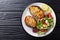 Freshly cooked sturgeon steaks served with fresh vegetable salad close-up on a plate. horizontal top view