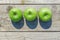 Freshly cropped geen apples on wooden table, top view